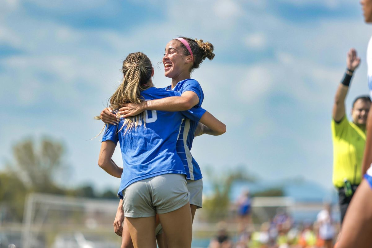 Junior Sydney Cook and Blair Satterfield celebrate after a goal against Carmel.