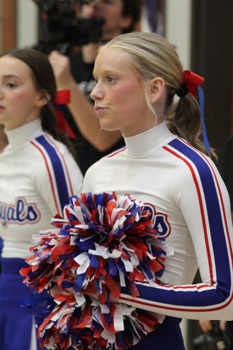 Senior Kate Kellum cheering at boys basketball game.