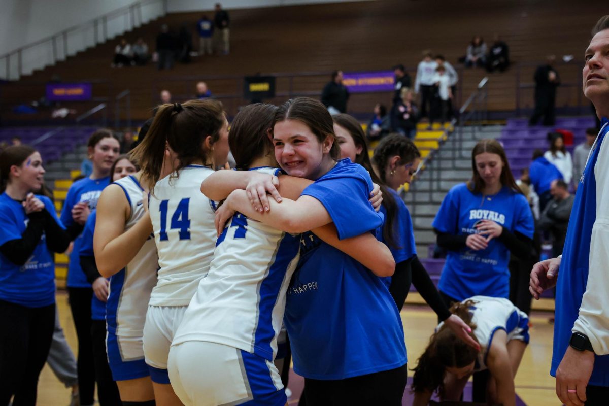 Macey Spreitzer celebrates with Addison Van Hoesen after the girls basketball team wins the regional title at Homestead on Feb. 15.