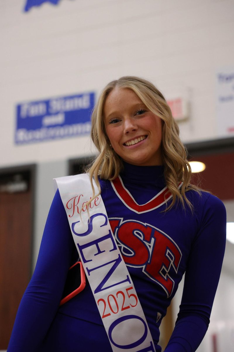 Kate Kellum poses at girls Basketball Cheer senior night.