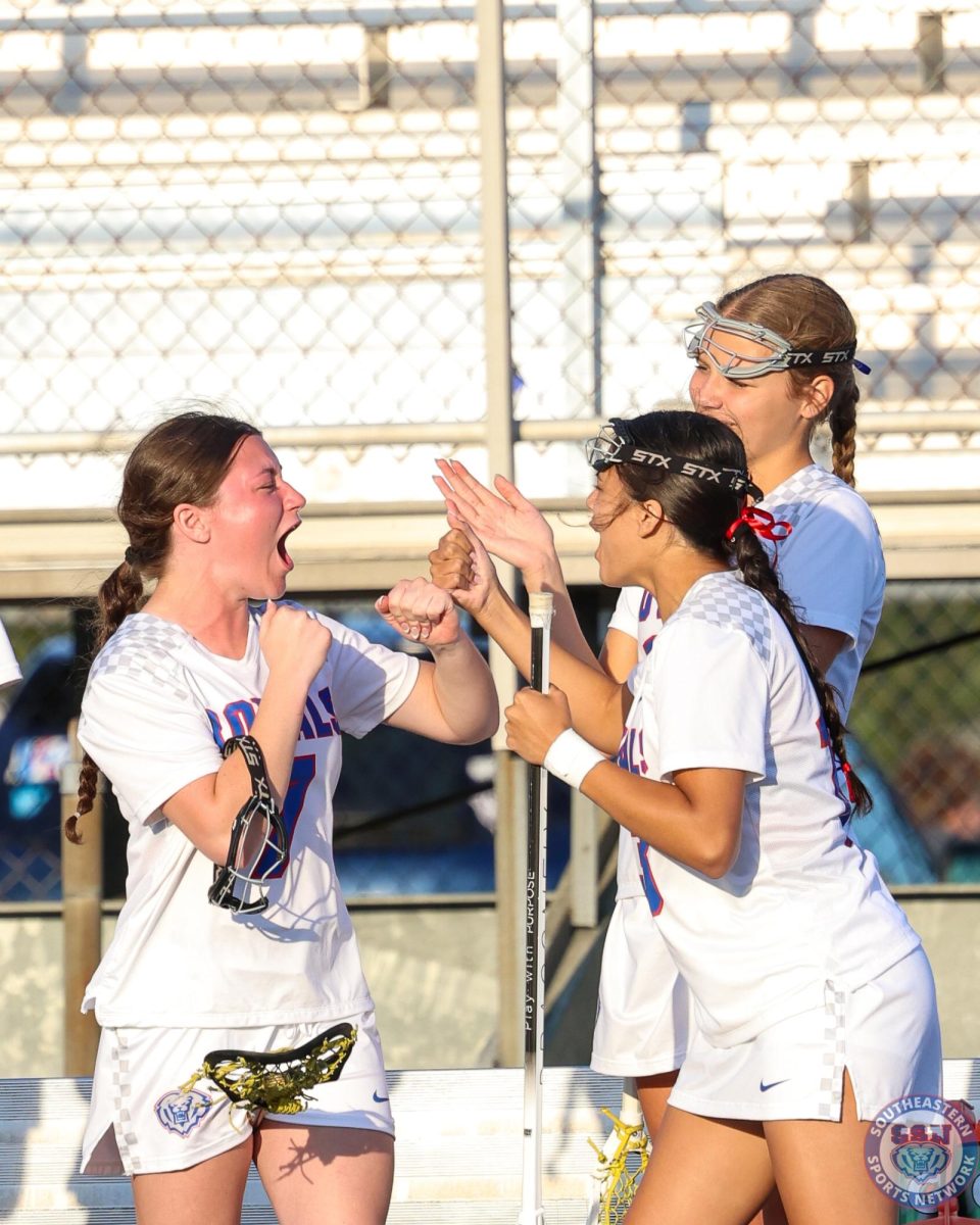 Girls lacrosse players celebrate together during their game against Heritage Christian High School at Hamilton Southeastern High School on April 16, 2026. 